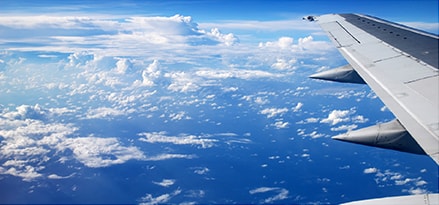 Blue sky view from the side of a plane