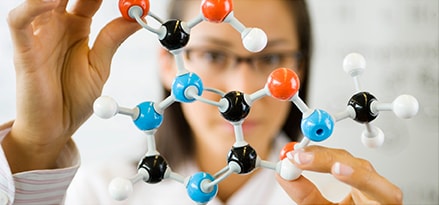 Female scientist holding molecule model