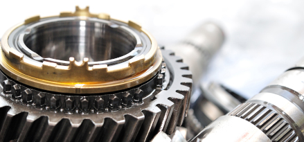 Close-up of a disassembled vehicle transmission with a golden ring.