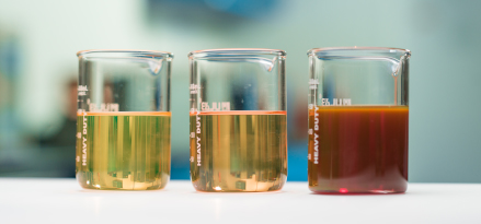 Laboratory beakers filled with various Group I Base Stocks.