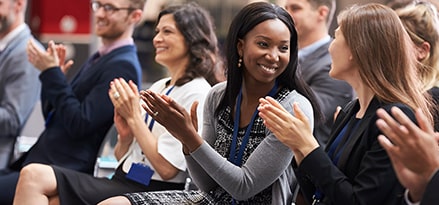 women clapping at conference