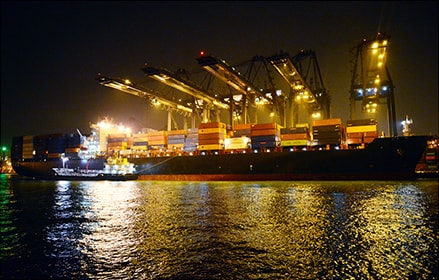 Cargo shipping port at night barge at night