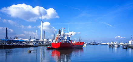 A large red and white boat on the water