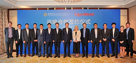 CMES attendees in front of a blue banner.