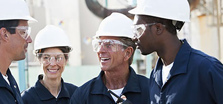 Group of workers in plant with protective gear