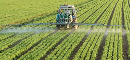 Tractor spraying crops