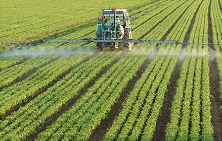 Tractor spraying crops