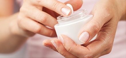 Woman applying hand cream