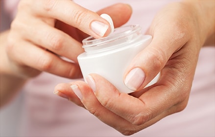 Woman applying hand cream