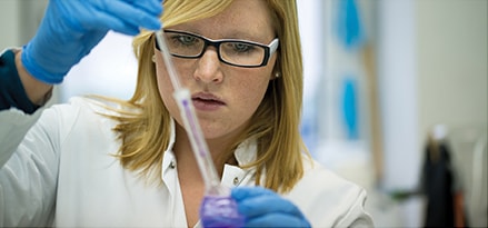 Female scientist testing chemicals in a lab