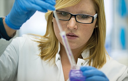 Female scientist testing chemicals in a lab